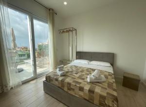 a bedroom with a bed and a large window at Attico Al Vomero in Naples