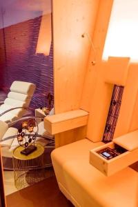 a room with a bed and a couch and chairs at Cozy House with Garden and Jacuzzi in Tournai in Tournai