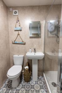 a bathroom with a toilet and a sink at Beach Snug in Lytham St Annes