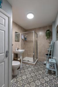a bathroom with a shower and a toilet and a sink at Beach Snug in Lytham St Annes