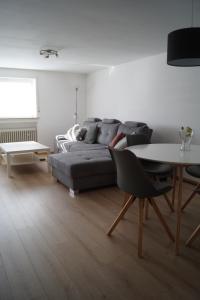 a living room with a couch and a table at Astentraum in Winterberg