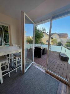 a room with a balcony with a table and a glass door at „1. SALZBURG work & sleep luxury apartment“ für arbeiten & wohnen ! in Salzburg