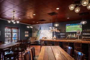 een bar met houten tafels en stoelen en een televisie bij Harrah's Gulf Coast Hotel & Casino in Biloxi