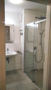 a bathroom with a shower and a sink at Sroom Metzingen in Metzingen