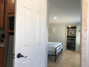 a door leading to a bedroom with a bed at Olancha RV Park and Motel in Olancha