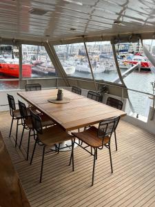 a wooden table and chairs on the deck of a boat at Yacht Aquamarina vieux port La Rochelle in La Rochelle