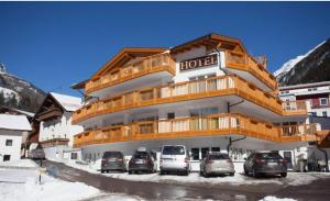a hotel with cars parked in front of it at Rooftop by Northsouth Apartments in Sölden