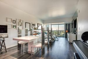 a kitchen and living room with a table and chairs at Luxury Condo in Marina del Rey with Pool in Los Angeles