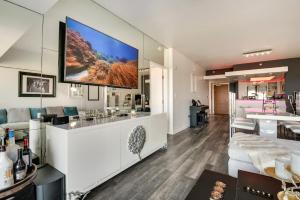 a living room with a large tv on the wall at Luxury Condo in Marina del Rey with Pool in Los Angeles