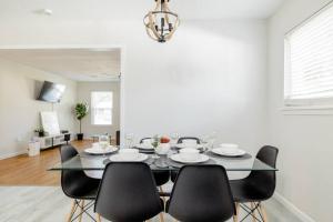 a dining room with a glass table and black chairs at 2 bed 2 bath Modern Farmhouse in Old Town Spring in Spring