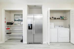 a stainless steel refrigerator in a white kitchen at 2 bed 2 bath Modern Farmhouse in Old Town Spring in Spring