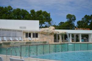 a swimming pool with a water fountain in front of a building at Villas Ropotamo in Primorsko