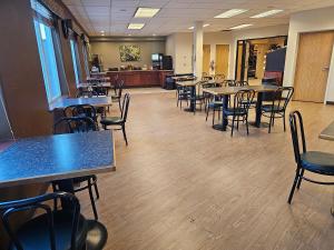 a room with tables and chairs and a cafeteria at Broadway Inn Conference Center in Missoula