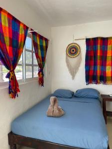 a bedroom with a bed with a stuffed animal on it at Brisa Del Mar in Holbox Island