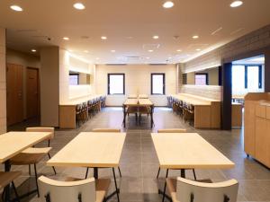a classroom with tables and chairs in a building at Super Hotel Namba Nipponbashi in Osaka
