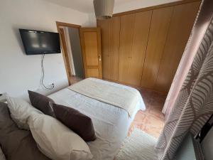 a bedroom with a bed and a flat screen tv at Casa Suu Valdelinares VUTE-23-025 in Valdelinares