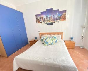 a bedroom with a large bed with blue cabinets at TurinHouse in Turin