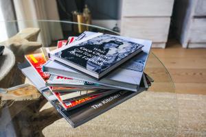 a stack of books sitting on a glass table at Penthouse at the Chocolate Box in Bournemouth