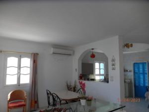 a kitchen and dining room with a table and chairs at Villa Amine MG in Fafou