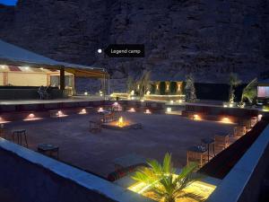 a patio at night with lights and tables and chairs at Rum Legend camp in Wadi Rum