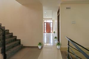um corredor com escadas e vasos de plantas num edifício em SPOT ON 70112 Sri Saptagiri Bording Lodging em Bangalore