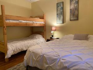 a bedroom with two bunk beds and a bed at 1949 Sweet Sage House, CLOSE to Airport, Temple and Highway in Idaho Falls