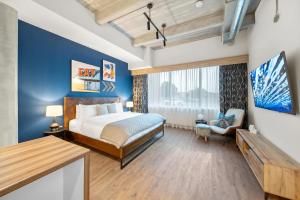 a bedroom with a bed and a large window at Cannery Lofts Niagara in Niagara Falls