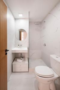 a white bathroom with a toilet and a sink at Top Rentals Deheza in Buenos Aires