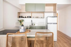a kitchen with a table and two chairs and a refrigerator at Top Rentals Deheza in Buenos Aires