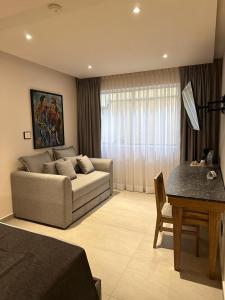 a living room with a couch and a table at Hotel Guadalajara Plaza Ejecutivo in Guadalajara