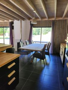 a dining room with a large table and chairs at ELLA in Aragnouet