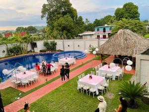 a group of people standing in front of a swimming pool at HOTEL MILIN in Villa Comaltitlán