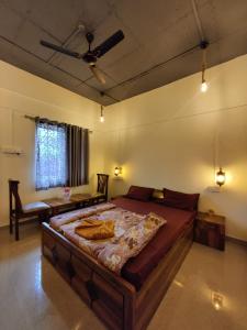 a bedroom with a large bed and a table at Shisha the lake-touch home stay mulshi in Waki