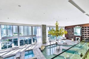 a large room with a pool and a chandelier at Amazing 2 Bedroom at Icon in the Heart of Brickell in Miami