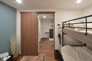 a room with a bunk bed and a hallway at Style Wood Nishi-Shinjuku 2nd floor 3rd floor - Vacation STAY 68984v in Tokyo