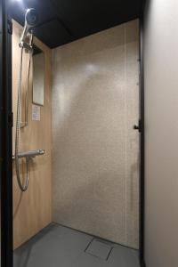 a shower stall with a glass door in a bathroom at Style Wood Nishi-Shinjuku 2nd floor 3rd floor - Vacation STAY 68984v in Tokyo