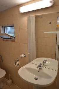 a bathroom with a sink and a mirror and a toilet at Villas Holidays in Primorsko +18 photos