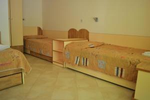 a room with three beds in a room at Villas Holidays in Primorsko
