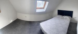 a white room with a bed and a window at Excellent 3bed flat in Kent