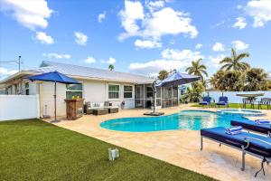 a backyard with a swimming pool and a house at Royal Blue Dreams flexible rental near Anna Maria Island in Bradenton