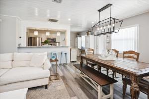 a dining room and living room with a table and a couch at Royal Blue Dreams flexible rental near Anna Maria Island in Bradenton