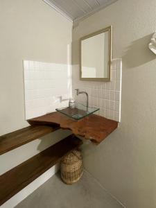 a bathroom with a sink and a mirror on a wall at OLITAS - Praia de algodões in Marau