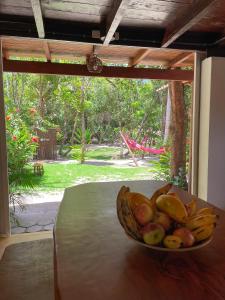 a bowl of fruit sitting on a table in front of a window at OLITAS - Praia de algodões in Marau