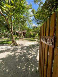 a wooden fence with a sign that reads toilets at OLITAS - Praia de algodões in Marau