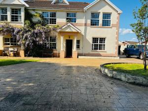a house with a driveway in front of it at A beautiful Large 7 bed house in Porthcawl
