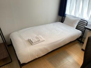 Cama en habitación con almohada en ＰＩＡＺＺＡーＵ - Vacation STAY 78021v, en Tokio
