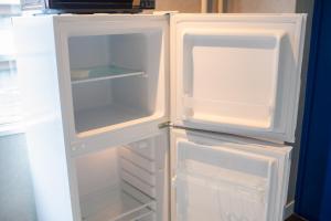 an empty refrigerator with its door open in a kitchen at Chatelet Yoyogi - Vacation STAY 15465 in Tokyo