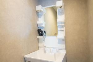 a bathroom with a sink and a mirror at Chatelet Yoyogi - Vacation STAY 15465 in Tokyo