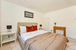 a bedroom with a large bed with red pillows at Charming Winchester Retreat in Winchester