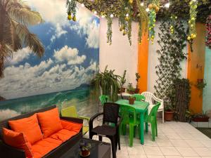 a room with a table and a painting on the wall at Amalfi's Place in Pimentel